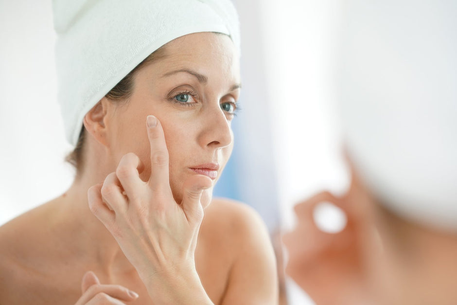 Untouched Face Day Cream pressed into the cheek at the mirror